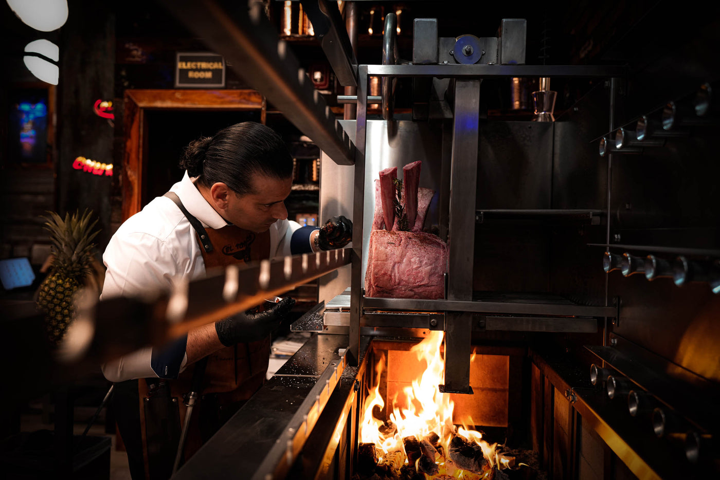 Person working with meat in a high-end restaurant kitchen